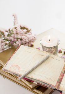 An open calendar and candle