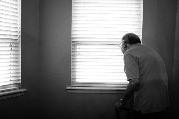An elderly man at a window